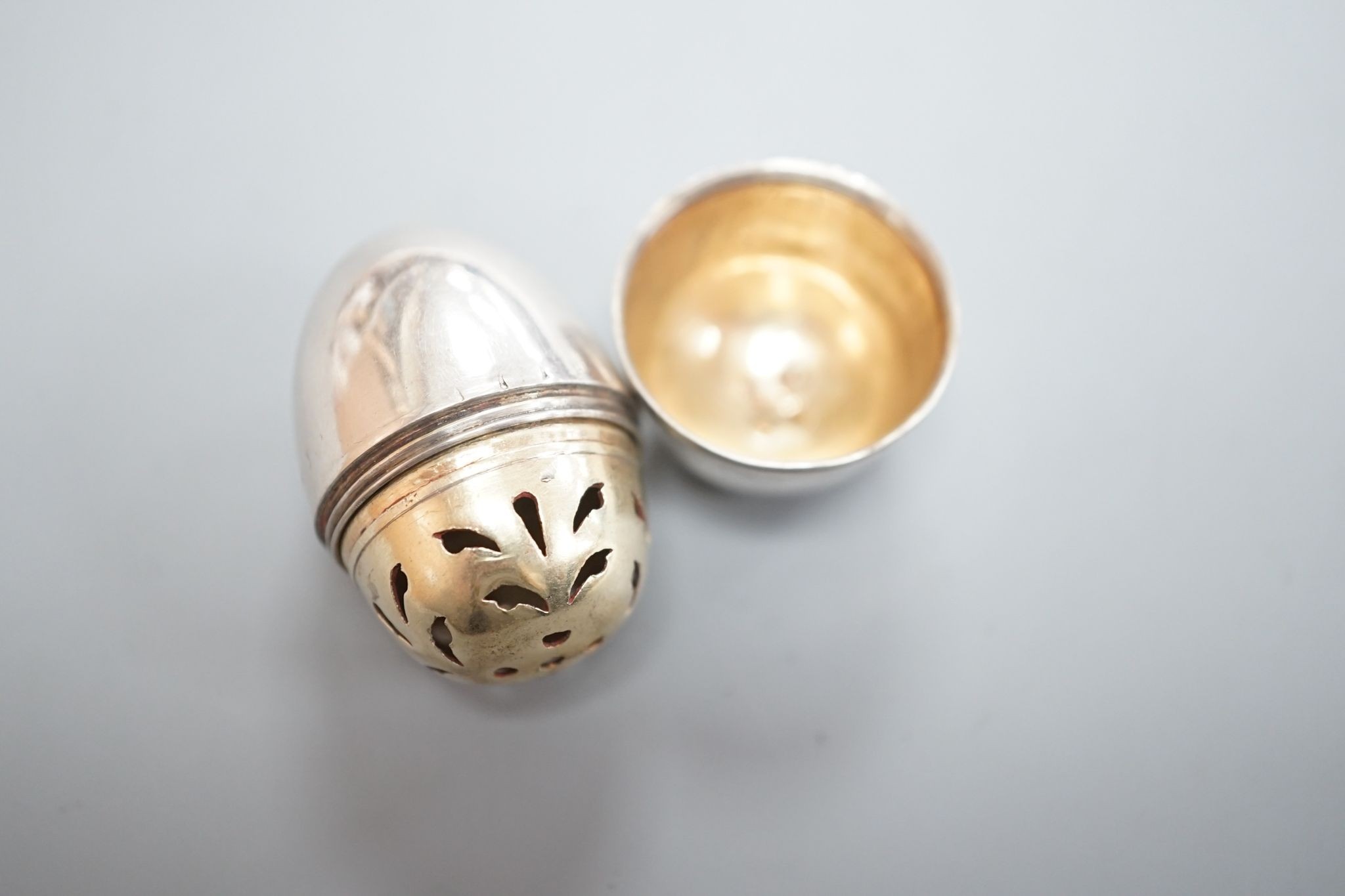 A George III silver egg shaped vinaigrette, by SM or WS, London, 1796, with engraved crest, 40mm.